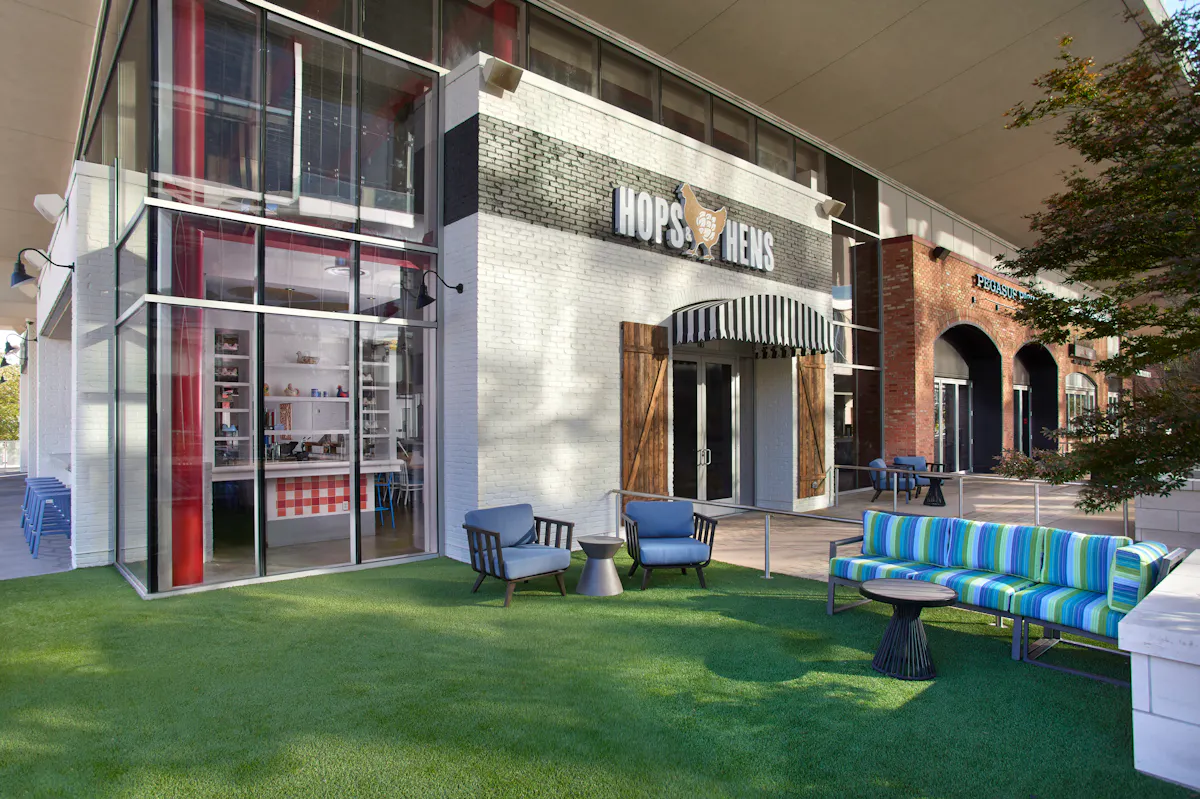 a patio with chairs and a table in front of a building